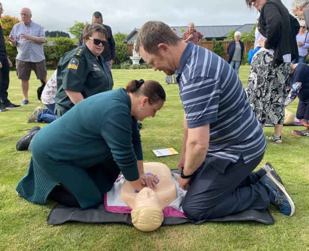 Blue Stone Dr resident Merie La Grange performs CPR as fellow resident Francois La Grange (right)...
