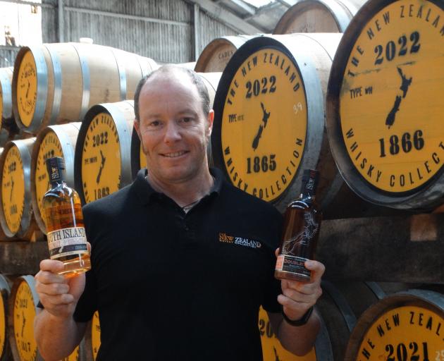 New Zealand Whisky Collection head distiller Michael Byars proudly shows off his two award...
