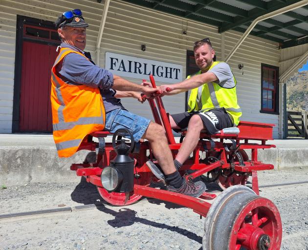Demonstrating the arm and leg-propelled "Velocipede" trolley are (from left) father and son Shem...
