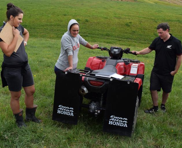 Learning about motorcycle maintenance in South Otago last week is (from left) DairyNZ farm...