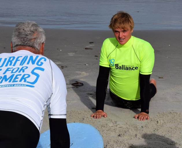 Surfing for Farmers instructor Pearce Mote, of Dunedin, provides instruction at Brighton Beach.