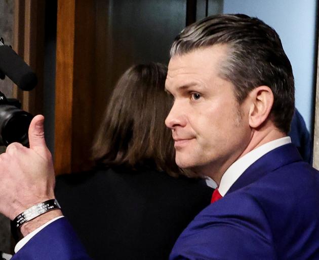 Pete Hegseth gives a thumbs-up as he leaves a Senate Committee on Armed Services confirmation...