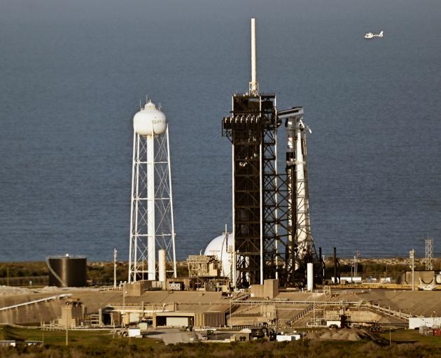 SpaceX’s Falcon 9 rocket rests on its launch pad at Kennedy Space Center in Cape Canaveral,...