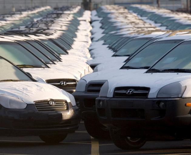Imported cars line a parking lot at a shipping terminal in Portland, Oregon in this file photo:...