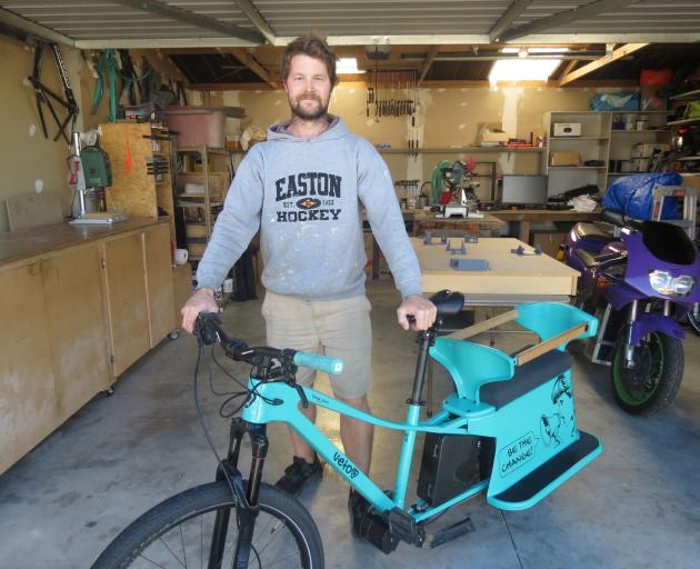 Alexandra man Scott Kvick poses with the first Long John bike in front of the shed the bike was...