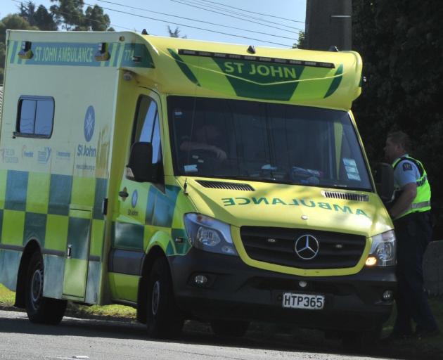A police officer talks to Hato Hone St John staff after a 10-year-old child was hit by a car in...