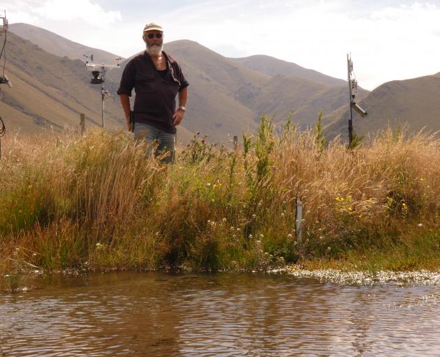 Mt Possession station owner Donald Whyte next to small stations measuring and monitoring weather,...