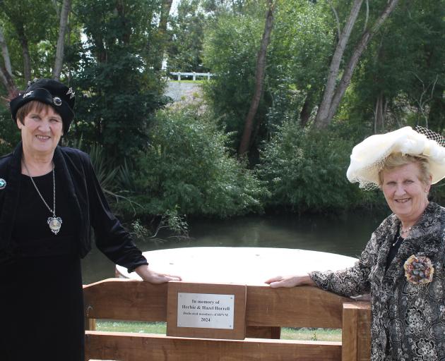 Standing by the plaque made in honour of their parents’ service to the Hokonui Pioneer Village...