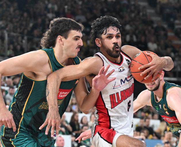 Auckland Tuatara guard William Hickey drives to the basket for the Illawarra Hawks during an...