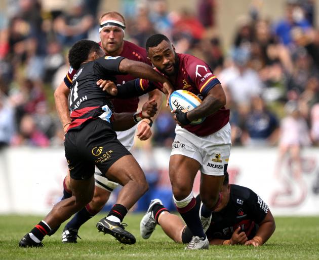 Highlanders winger Jona Nareki attacks the Crusaders defence during the preseason game in...