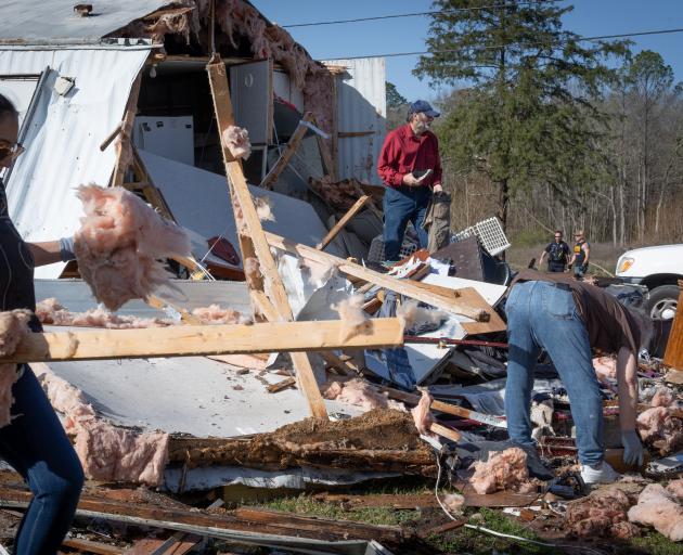 Clean-up begins in the Alabama town of Calera after a tornado ripped through houses. Photo: Getty...