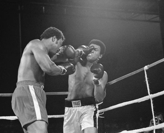 Foreman lands a punch on Muhammad Ali at the Rumble in the Jungle in Kinshasa, Zaire (now the...