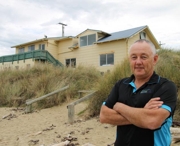 Kaka Point Surf Life Saving Club chairman Mark van Asperen in front of the clubrooms which are up...