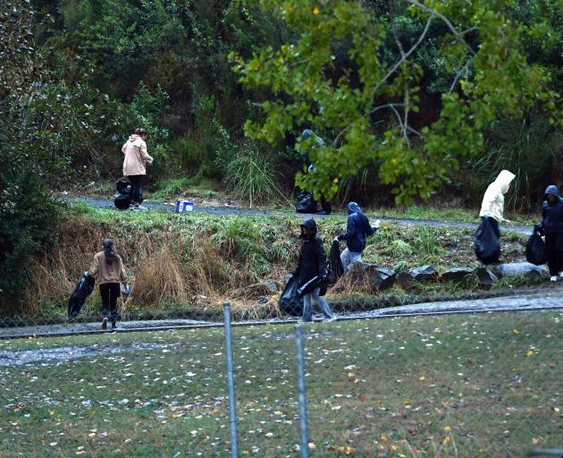Roads leading to the Lake House flat are cleaned of St Patrick's day rubbish this morning. Photo:...