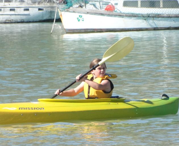 Piper Robinson, 8, paddles in Oamaru Harbour.