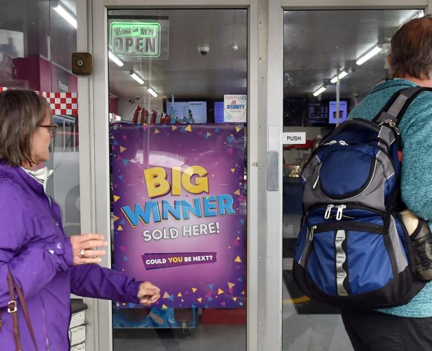 Customers in Port Chalmers consider buying a Lotto ticket at the Windsor On the Spot Express...
