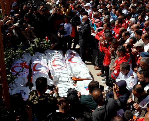 Palestinians mourn medics, who came under Israeli fire while on a rescue mission, after their...