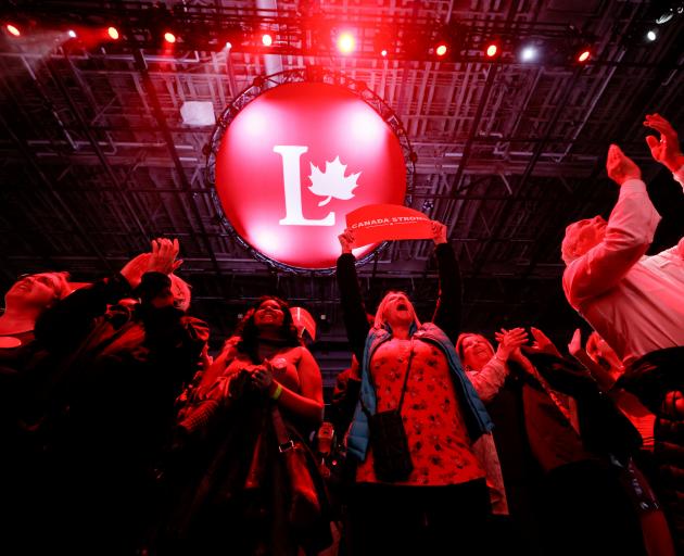 Liberal Party supporters celebrate polling numbers at their election night headquarters in Ottawa...