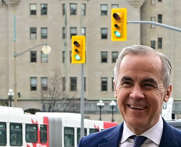Canada's Prime Minister Mark Carney walks into his office after the Liberal Party staged a major...