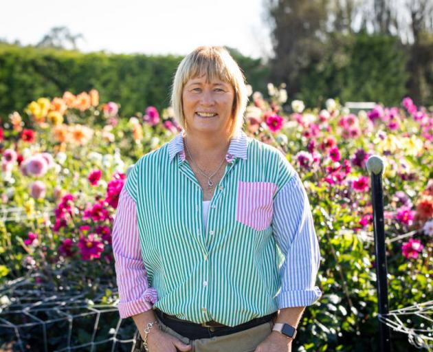 Vanessa Robinson with her dahlias. Photo: RNZ / Nate McKinnon
