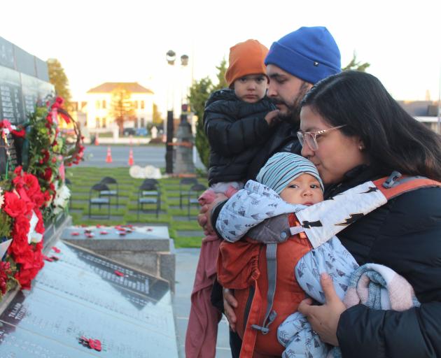 Andriana Treba kisses baby Nico as Jesse Hall holds on to their son Joe, 3, while they have a...
