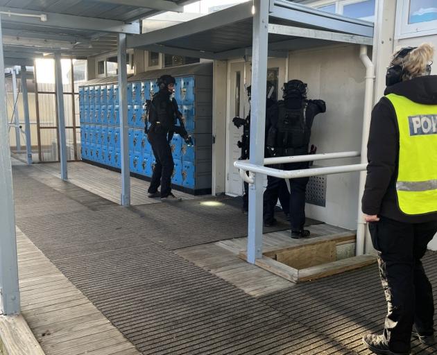 Members of the Armed Offenders squad rush into Cromwell College during a drill last week. PHOTO:...