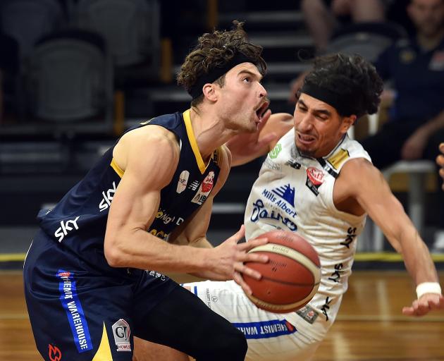Otago Nuggets guard Matt Bardsley evades Wellington Saints guard Rangimarie Dougall-Mita during...