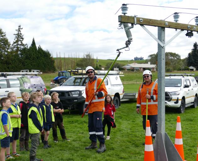 PowerNet staff Tyler Bouwer (left) and Dan Marshall educate year 4 pupils from Heriot and...