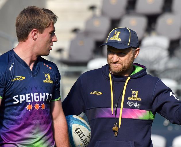 Highlanders first five Cameron Millar gets some advice from former coach Tony Brown ahead of...
