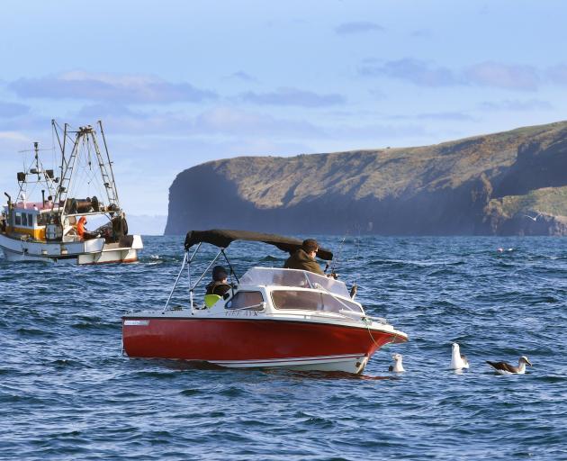 A recreational fishing boat and a commercial fishing trawler at Cape Saunders. PHOTO: STEPHEN...