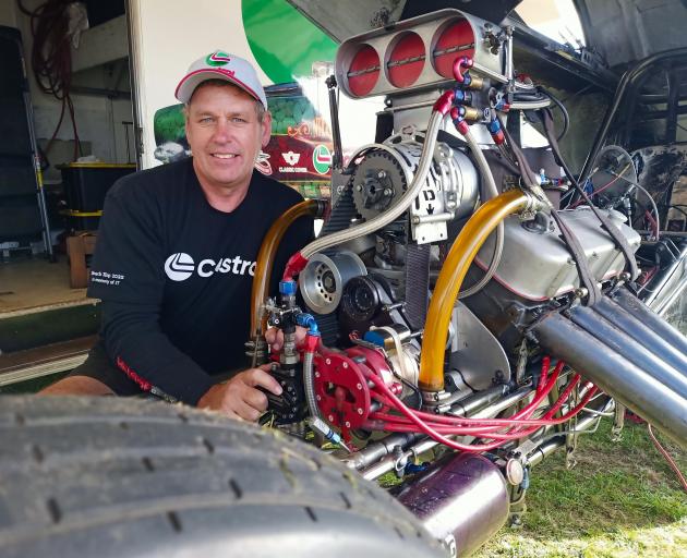 Karl Boniface checks under the hood of his Nitro Flashback funny car. The engine is a 438ci cast...
