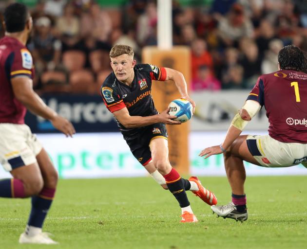 Damian McKenzie of the Chiefs makes a break during tonight's Super Rugby Pacific match against...