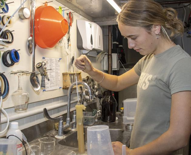 Lincoln Universty student Poppy Pett tests the beer temperature. PHOTO: GEOFF SLOAN