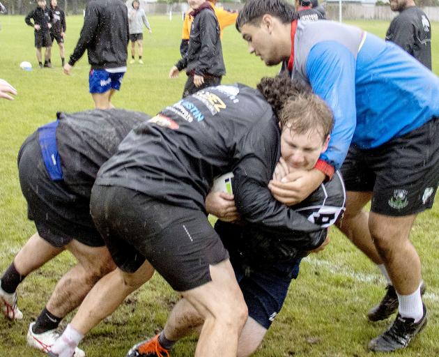 Sam Coughlan runs the ball into contact. Photo: Geoff Sloan