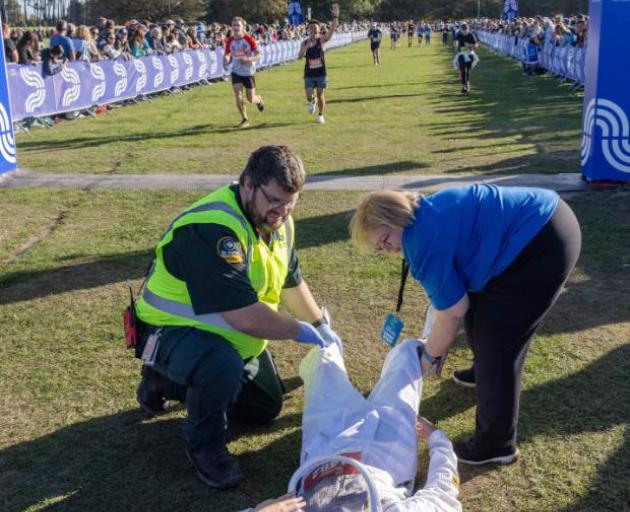 Ryan Yoo receives medical attention after cramping following his successful world record attempt...