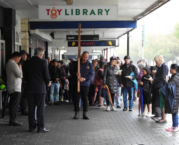 The procession pauses for reflection in Thames St. PHOTO: BRENDON MCMAHON