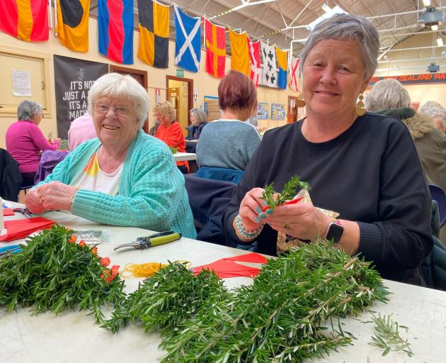 Making posies on Thursday are (from left) Patricia Goding, Katie Armstrong, 11, her grandmother...