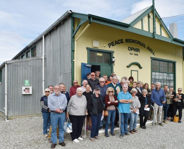 The Ophir community outside the Ophir Peace Memorial Hall after a meeting to discuss the hall’s...