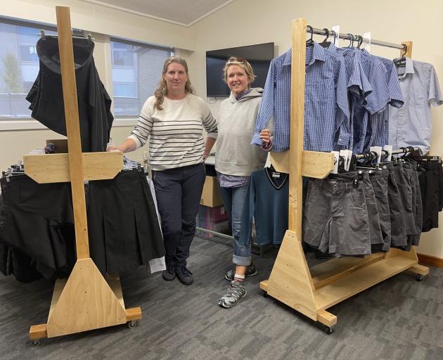 Jo Kitto (left) and volunteer Anna Brown in the uniform shop with brand-new clothing racks made...