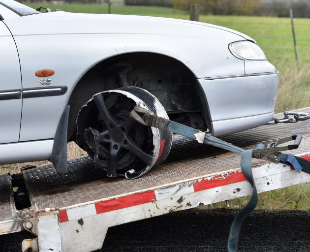 The car gets towed after being spiked during a police chase from Dunedin to Palmerston yesterday. 