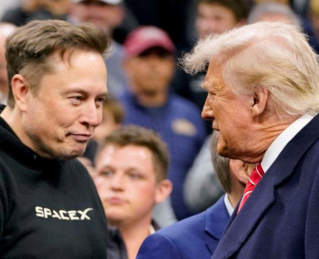 Elon Musk (L) greets US President Donald Trump at a wrestling event in Philadelphia in March....