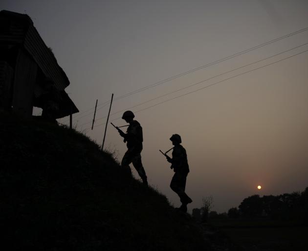 Indian Border Security Force soldiers patrol near the India-Pakistan international border...