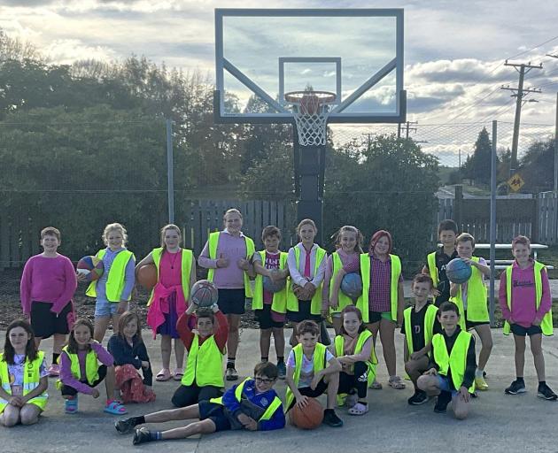 Heriot primary school seniors under the new hoop at the towns refurbished courts, last week....