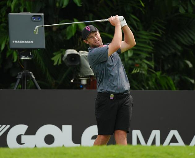 Ben Campbell reacts after a tee shot during the LIV Golf event at the Sentosa Golf Club in...