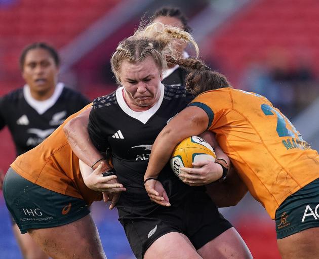 Black Ferns prop Amy Rule charges at the Wallaroos defence during the opening game in the Pacific...