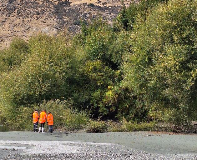 Contractors monitoring water quality near the wastewater discharge site on the Shotover River....