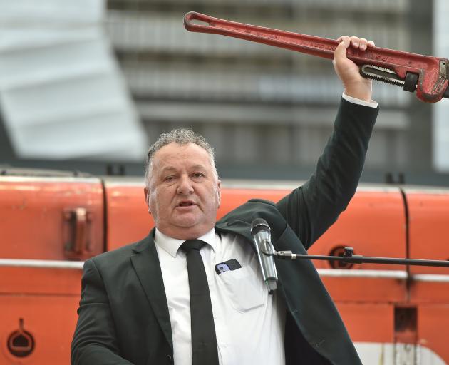 Regional Development Minister Shane Jones holds up a red wrench as he addresses a crowd at the...