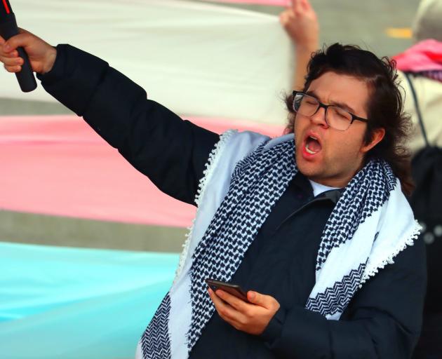 Stand against Transphobia co-ordinator Oscar Bartle leads a protest chant during the event.
