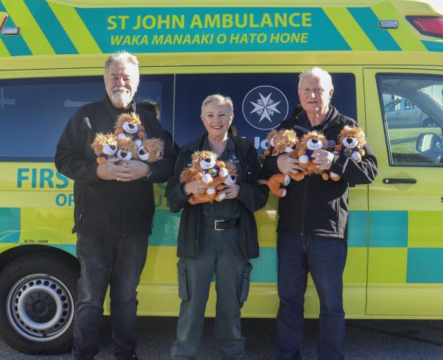 Handing over armfuls of toy lions to St John chairwoman Dell Taylor to help out the St John team...