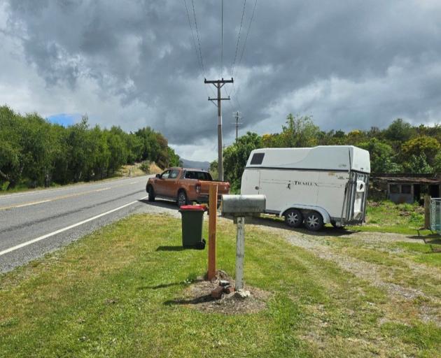 Heather Morris drives her vehicle and horse float out of her driveway on to State Highway 8 just...
